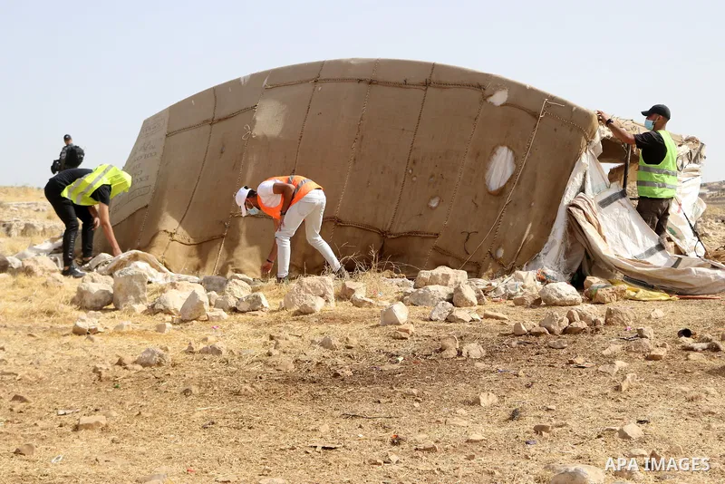 Evicted Palestinian residents pack their belongings during an Israeli demolition of Palestinian homes located within the "Area C" of the occupied West Bank, where Israel retains full control over planning and constructio...