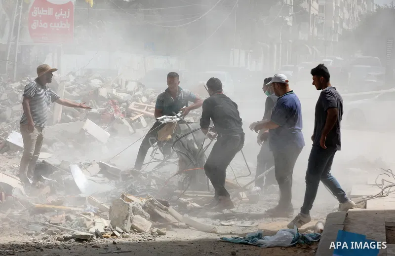 Palestinian workers remove rubble of the Abu Al-Aouf building, that was destroyed by Israeli air strikes, in Gaza City, on May 31, 2021. Gaza’s housing ministry said on Thursday that 16,800 housing units had been damaged...
