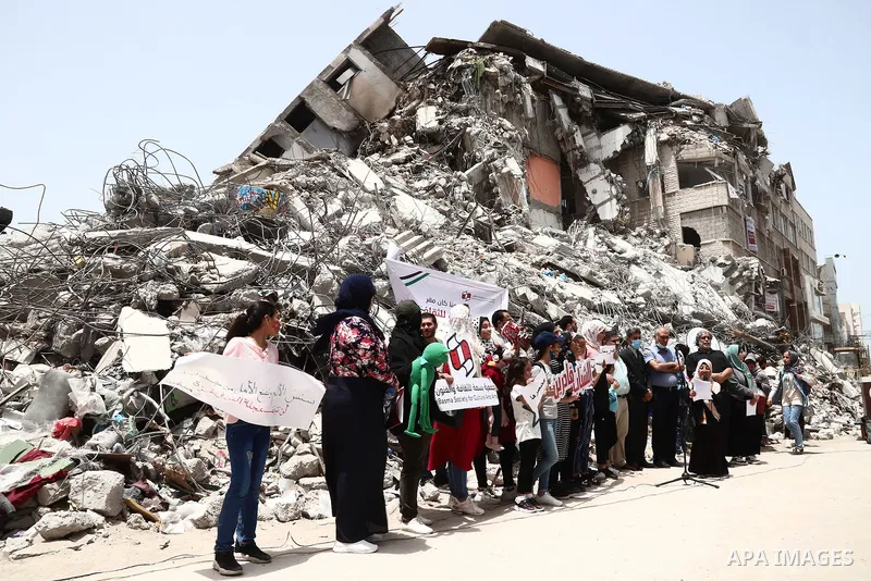 Members of Basma society for culture and arts take part in a protest against the destroyed of their headquarter by Israeli air strikes which located at Shorouq tower in Gaza city on May 31, 2021. Gaza’s housing ministry...