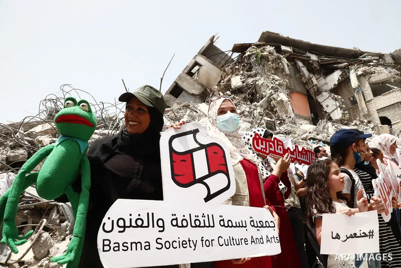 Members of Basma society for culture and arts take part in a protest against the destroyed of their headquarter by Israeli air strikes which located at Shorouq tower in Gaza city on May 31, 2021. Gaza’s housing ministry...