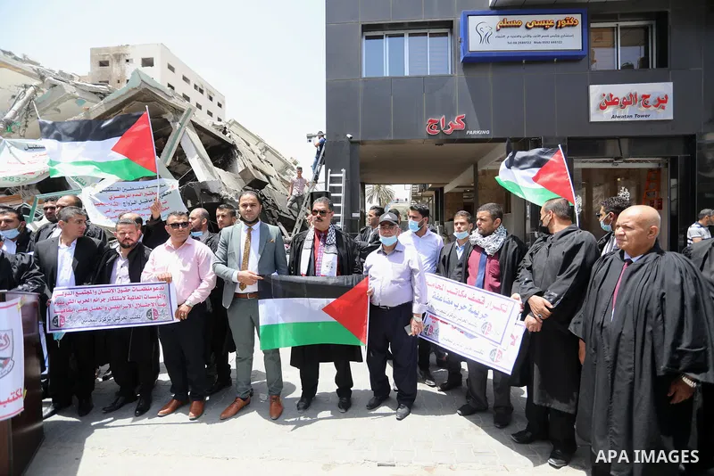 Palestinian lawyers take part in a protest against Israeli violations, in front of Jala' Tower which destroyed which destroyed on May 15 during Israeli air-strike in Gaza city on June 1, 2021. As Gaza tries to recover fr...