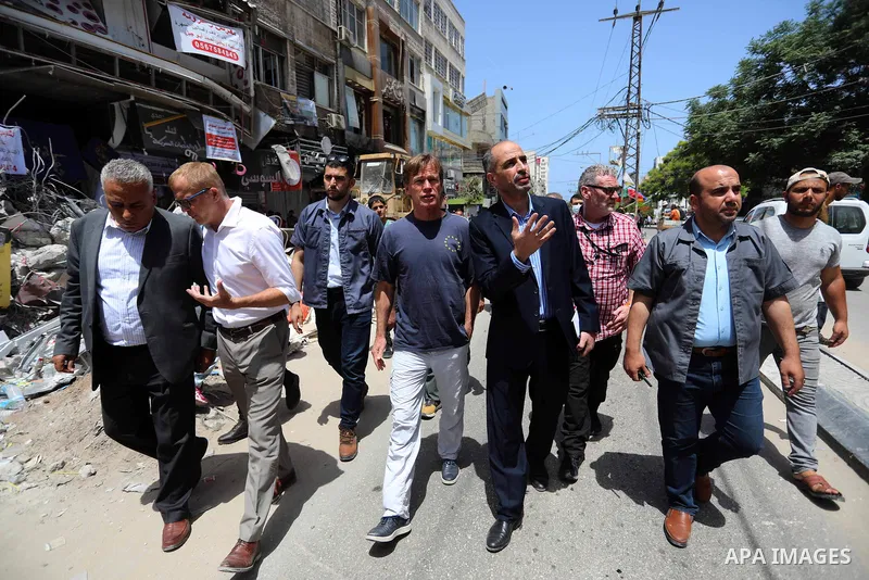 Sven Kühn von Burgsdorff, European Union Representative to the West Bank and Gaza, is given a tour of the ruins of al-Shouroq tower, destroyed by Israeli strikes during the recent confrontations between Hamas and Israel,...