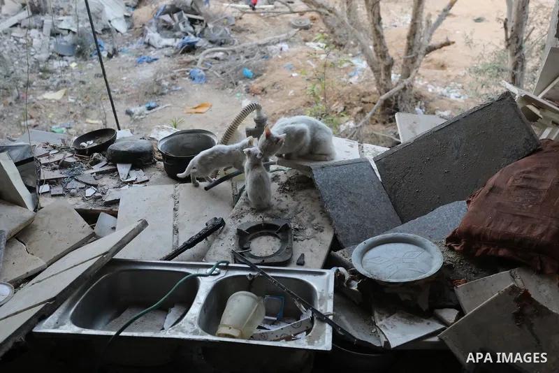 Palestinians gather at the rubbles of their homes which was destroyed last month after Israeli airstrikes in Beit Hanoun, in the northern Gaza Strip, on June 01, 2021. Gaza’s housing ministry said on Thursday that 16,800...