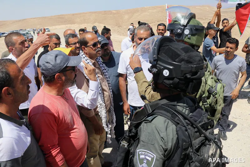 A Palestinian demonstrator argues with an Israeli soldier during a protest against Israeli settlements near Hebron in the Israeli-occupied West Bank June 4, 2021. Photo by Mosab Shawer