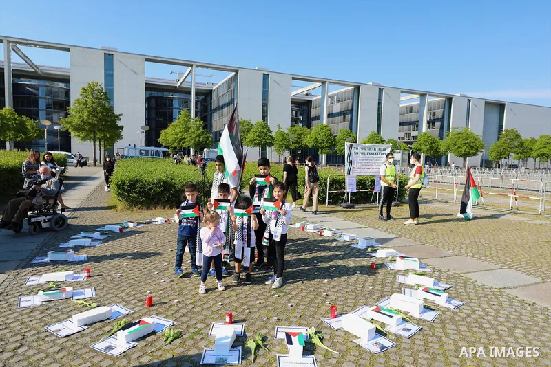 Foreign activists take part during a protest against the killed of Palestinian children at Gaza city by Israeli airstrikes, in front of German Bundestag, in Berlin, Germany, on June 4, 2021. Photo by Manar Shahin