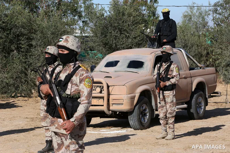Palestinian militants of Al-Aqsa Martyrs' Brigades, the armed wing of Fatah movement take part in a military parade in an anti-Israel rally, in Khan Younis in the southern of Gaza Strip June 7, 2021. Photo by Abed Deeb