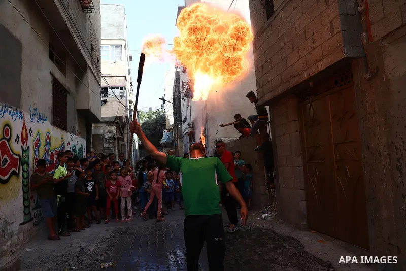 Palestinian volunteers perform acrobatic show in front of children during a mental health support session in Gaza city on June 9, 2021. As Gaza tries to recover from the deadly 11-day Israeli attack, mothers and mental h...
