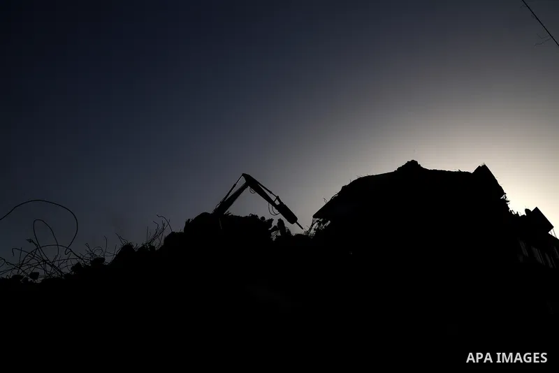 Egyptian bulldozers sent from Egypt help to remove the rubble of Shorouq tower destroyed by Israeli air strikes last month in Gaza city on June 9, 2021. After brokering a ceasefire between the Israelis and Hamas movement...