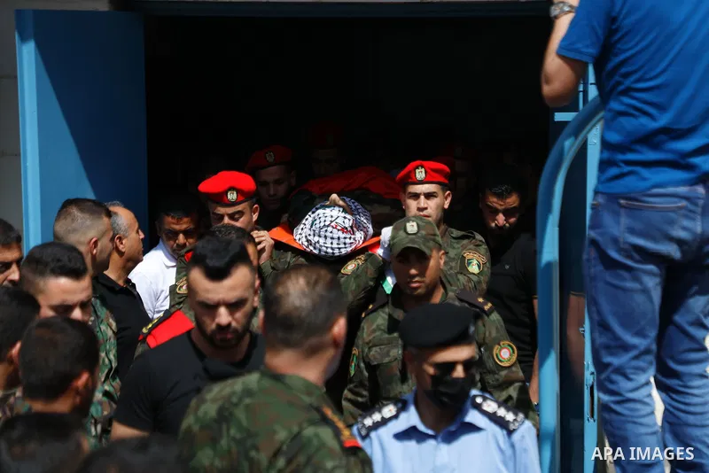 Mourners carry the body of Palestinian security man Tayseer Issa, who was killed by Israeli forces according to health ministry, during his funeral in the Werst bank city of Jenin, on June 10, 2021. Photo by Oday Daibes