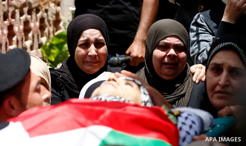 Members of Palestinian security forces carry the body of their comrade Adham Alioh, who was killed by Israeli forces according to health ministry, during his funeral in the West Bank city of Nablus on June 10, 2021. Phot...