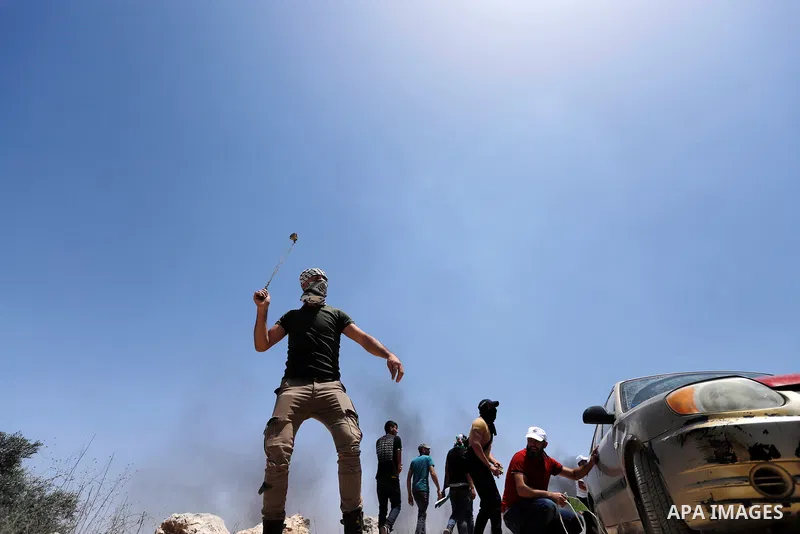 Palestinian protesters clash with Israeli security forces following a demonstration against Israeli settlement in the village of Beita, south of Nablus, in the West Bank on June 11, 2021. Photo by Shadi Jarar'ah