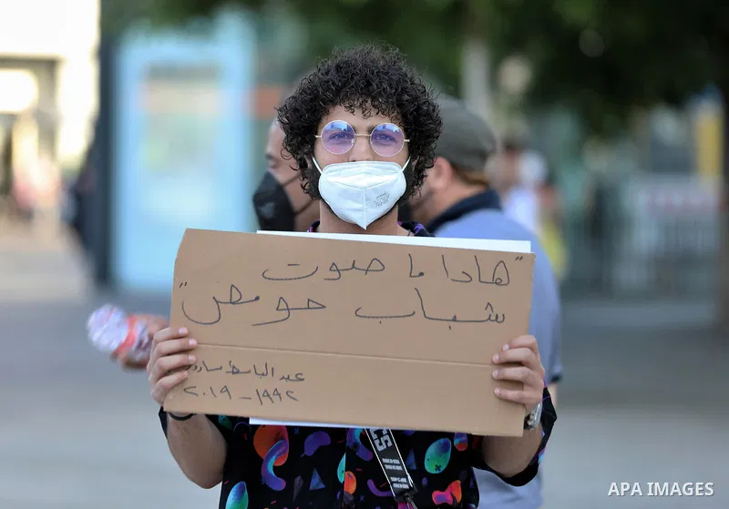 Syrians in Germany hold placards during a rally to commemorate the late rebel fighter and famous chanter Abdel-Basset al-Sarout, in In the German capital, Berlin, on June 11, 2021. Photo by Manar Shahin