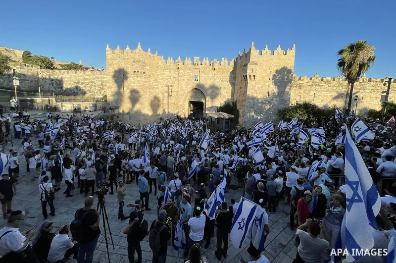 Israeli ultranationalists wave flags during the March of the Flags near Jerusalem's Old City celebrating the anniversary of Israel's 1967 occupation of Jerusalem's eastern sector on June 15, 2021. Photo by Baraah Abo Ram...