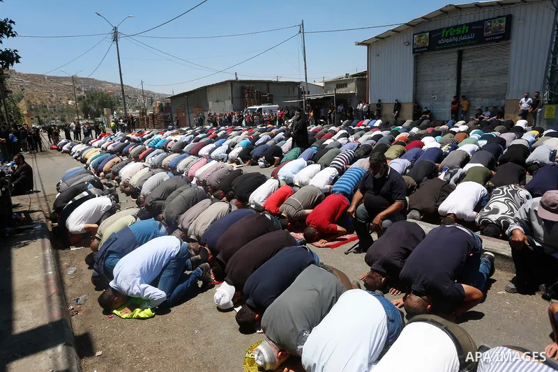 Palestinians pray Friday prayer before a protest against Israeli settlements in the village of Beita near the West Bank city of Nablus, on June 18, 2021. Photo by Shadi Jarar'ah