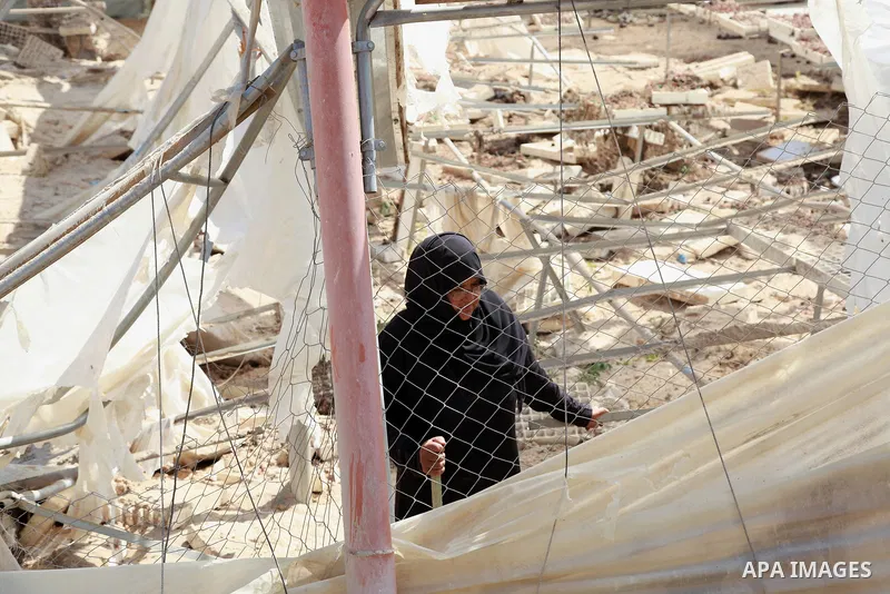 A Palestinian woman inspects damage at her hydroponics greenhouse, which was destroyed by Israeli air strikes during the May 2021 conflict between Hamas and Israel, in Beit Lahia in the northern Gaza Strip, on June 20, 2...