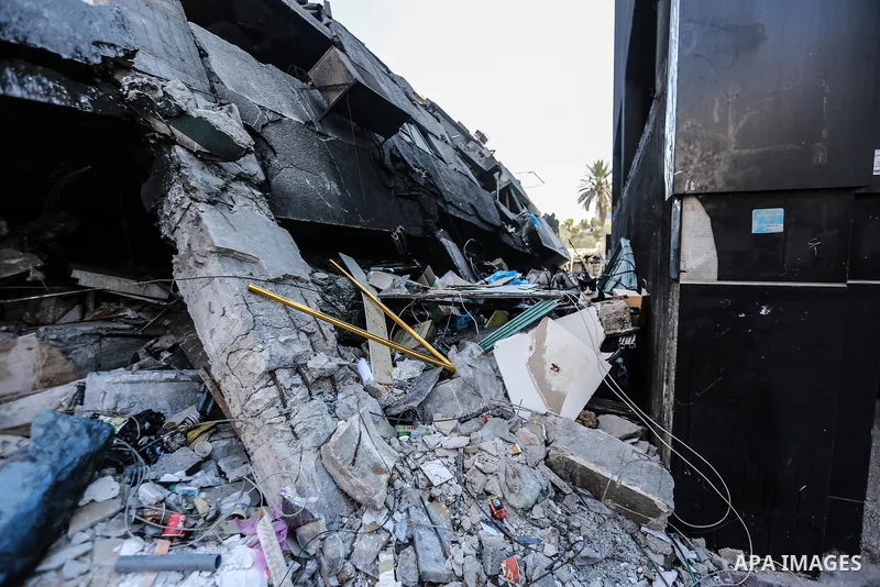 A cat sits on the rubbles of of Jala' Tower which destroyed on May 15 during Israeli air-strike, in Gaza city, on June 20, 2021. Photo by Bashar Taleb