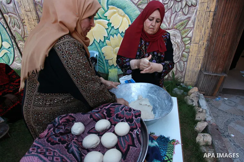Palestinians take part in a heritage Festival on the occasion of World Refugee Day, at Nuseirat refugee camp, in the center of Gaza Strip on June 20, 2021. Palestine refugees are defined as “persons whose normal place of...
