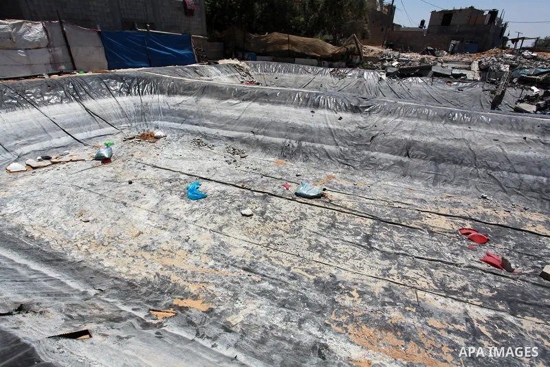 Palestinian man Iyad al-Attar, 46, inspects the fish's farm in Beit Lahia in the northern of Gaza Strip on June 22, 2021. Fish farms in Gaza strip were subjected to material loss, cause of The latest Israeli military esc...