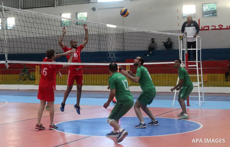 Palestinian players of Khadamat Jabalia team and players of Etihad Beit Hanoun team in actions during Volleyball match in Gaza city on June 22, 2021. Photo by Ali Hamad