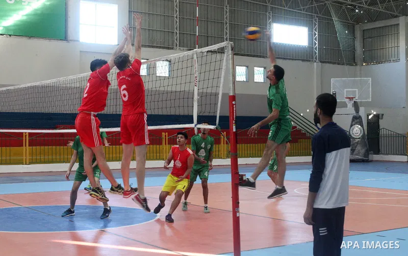 Palestinian players of Khadamat Jabalia team and players of Etihad Beit Hanoun team in actions during Volleyball match in Gaza city on June 22, 2021. Photo by Ali Hamad