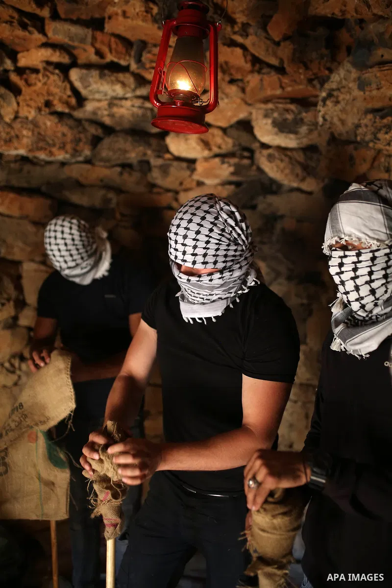 Palestinians prepare torches before a night demonstration against the expansion of a Jewish settlement on the lands of Beita village, near the occupied West Bank city of Nablus, on June 23, 2021. Photo by Shadi Jarar'ah