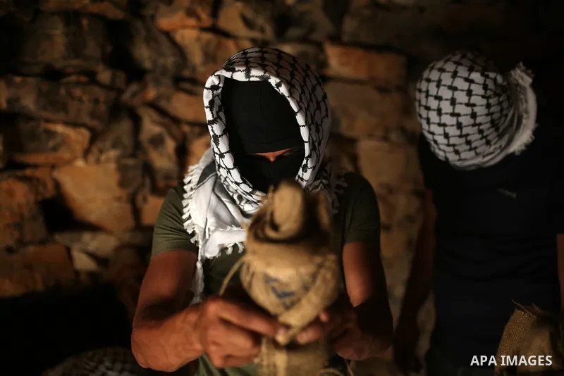 Palestinians prepare torches before a night demonstration against the expansion of a Jewish settlement on the lands of Beita village, near the occupied West Bank city of Nablus, on June 23, 2021. Photo by Shadi Jarar'ah