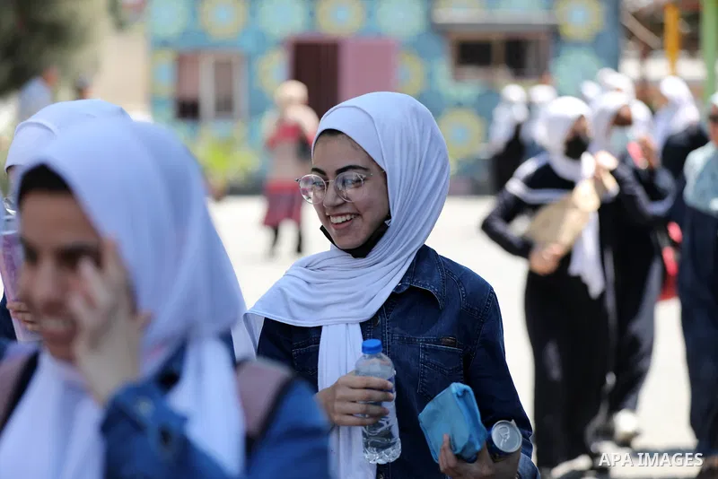 Palestinian students stand outside their school after completing the final high school exam, in Gaza City on June 24, 2021,amid concerns about the spread of the novel coronavirus pandemic. More than 84598 students in the...