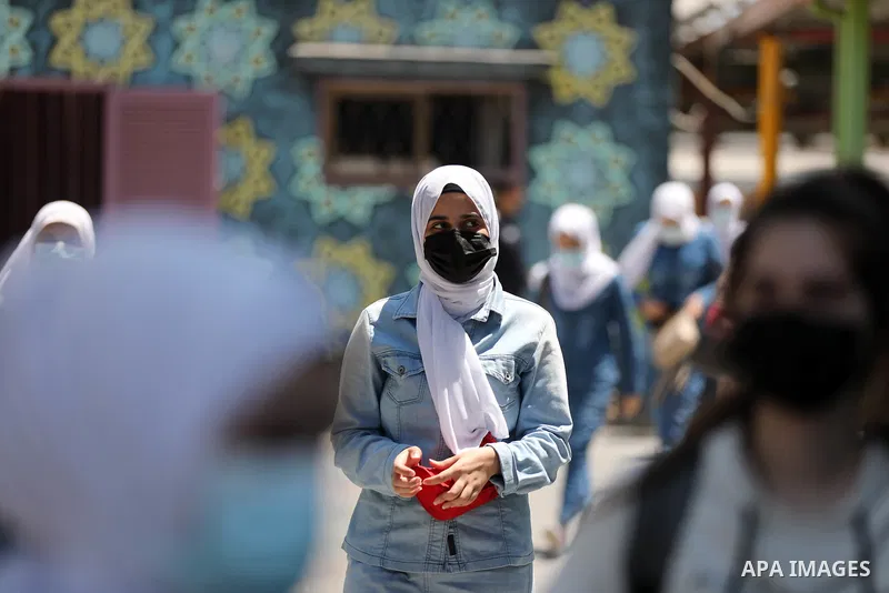 Palestinian students stand outside their school after completing the final high school exam, in Gaza City on June 24, 2021,amid concerns about the spread of the novel coronavirus pandemic. More than 84598 students in the...