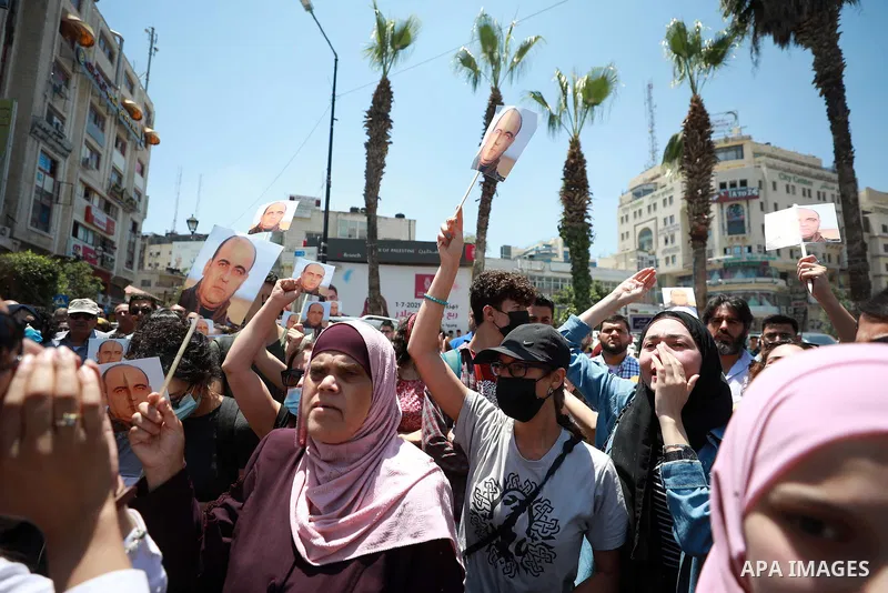 Demonstrators gather during a protest following the death of Palestinian parliamentary candidate and activist Nizar Banat, who died after being arrested by Palestinian Authority's security forces, in the West Bank city o...