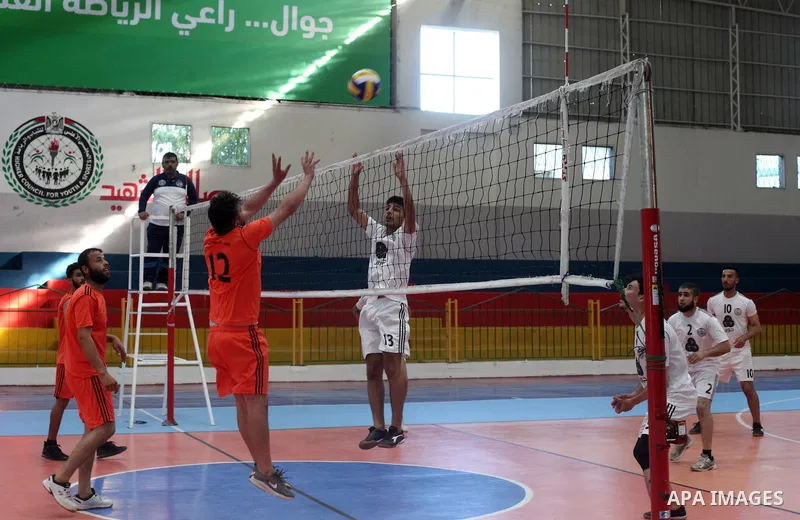 Palestinian players of Moghraqa team and players of el-Ribat team in actions during Volleyball match in Gaza city on June 24, 2021. Photo by Ali Hamad