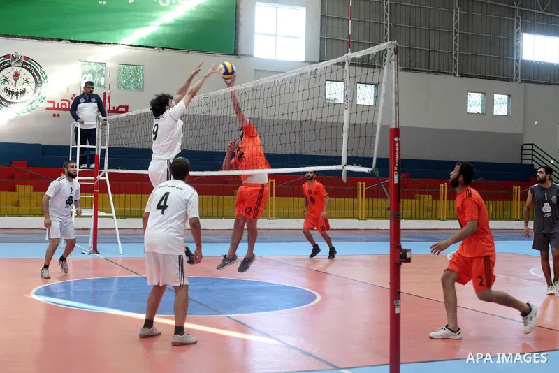 Palestinian players of Moghraqa team and players of el-Ribat team in actions during Volleyball match in Gaza city on June 24, 2021. Photo by Ali Hamad