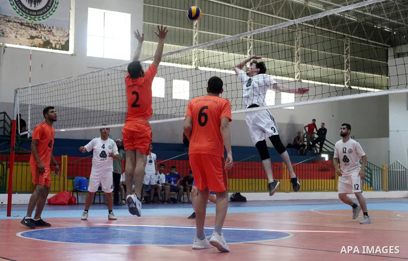 Palestinian players of Moghraqa team and players of el-Ribat team in actions during Volleyball match in Gaza city on June 24, 2021. Photo by Ali Hamad