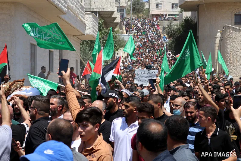 Mourners walk in a funerary procession with the body of human rights activist and Palestinian parliamentary candidate Nizar Banat, who died shortly after being arrested a day before, in Hebron in the West Bank on June 25...