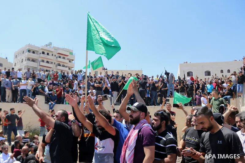 Mourners walk in a funerary procession with the body of human rights activist and Palestinian parliamentary candidate Nizar Banat, who died shortly after being arrested a day before, in Hebron in the West Bank on June 25...