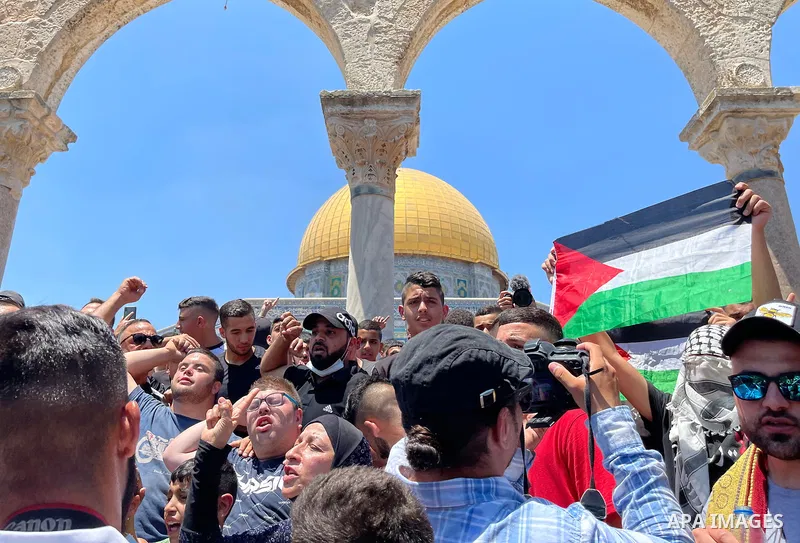 Palestinians protest at the al-Aqsa mosque compound in Jerusalem on June 25, 2021 after Palestinian parliamentary candidate and activist Nizar Banat, who death being arrested by Palestinian Authority security forces. Tho...