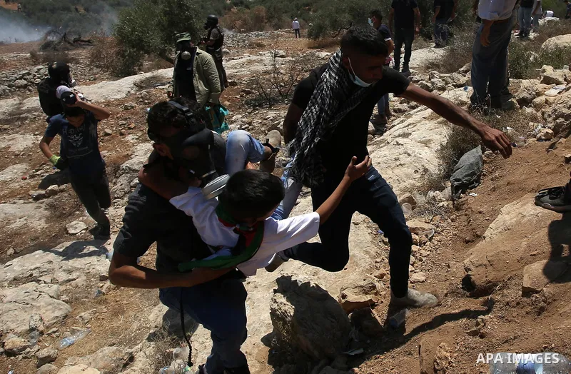 Palestinian demonstrators clash with Israeli security forces after a protest against the newly built Israeli settlers' outpost of Eviatar in the town of Beita, near Nablus in the north of the occupied West Bank, on June...