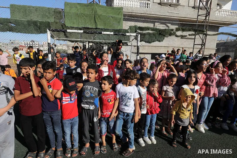 Palestinian children participate in a mental health support session during entertainment festival after the latest Israeli escalation, in Rafah in the southern Gaza Strip, on June 25, 2021. Photo by Abed Deeb