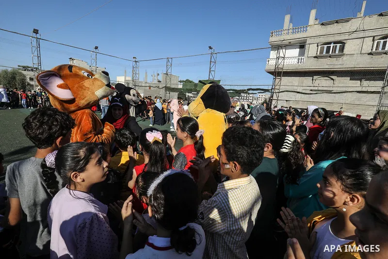 Palestinian children participate in a mental health support session during entertainment festival after the latest Israeli escalation, in Rafah in the southern Gaza Strip, on June 25, 2021. Photo by Abed Deeb
