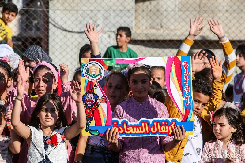 Palestinian children participate in a mental health support session during entertainment festival after the latest Israeli escalation, in Rafah in the southern Gaza Strip, on June 25, 2021. Photo by Abed Deeb
