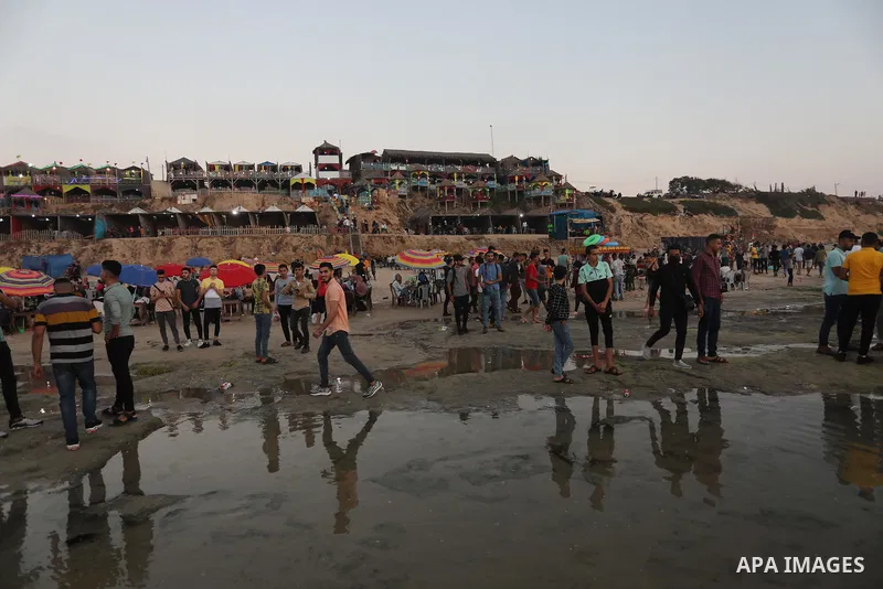 Palestinians enjoy the beach of the Mediterranean sea in Deir al-Balah in the center of Gaza Strip, on June 25, 2021. The beach is one of the few open public spaces in this densely populated city. Photo by Ashraf Amra