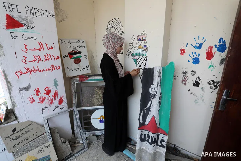 Palestinian artist Saja Moussa draws on broken tiles from her family's house in Rafah refugee camp, southern Gaza Strip, on June 26, 2021. The house was damaged last month during an 11-day war between Israel and the Hama...