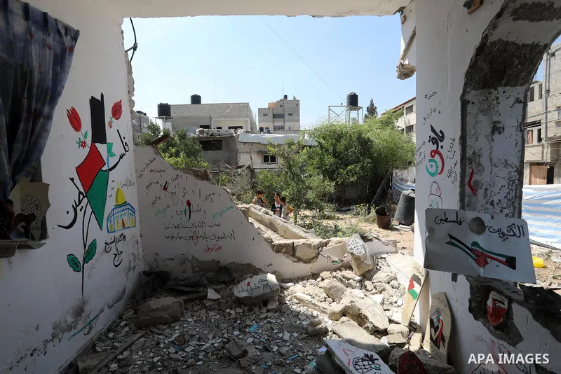 Palestinian artist Saja Moussa draws on broken tiles from her family's house in Rafah refugee camp, southern Gaza Strip, on June 26, 2021. The house was damaged last month during an 11-day war between Israel and the Hama...