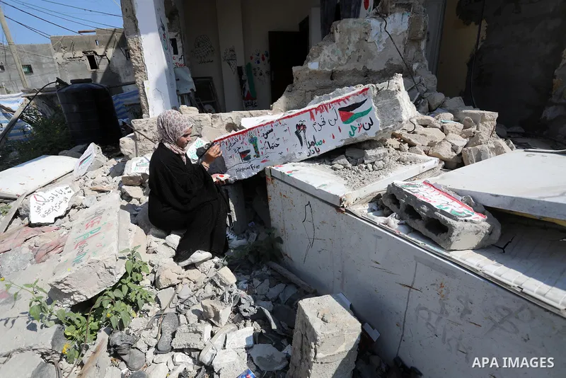 Palestinian artist Saja Moussa draws on broken tiles from her family's house in Rafah refugee camp, southern Gaza Strip, on June 26, 2021. The house was damaged last month during an 11-day war between Israel and the Hama...