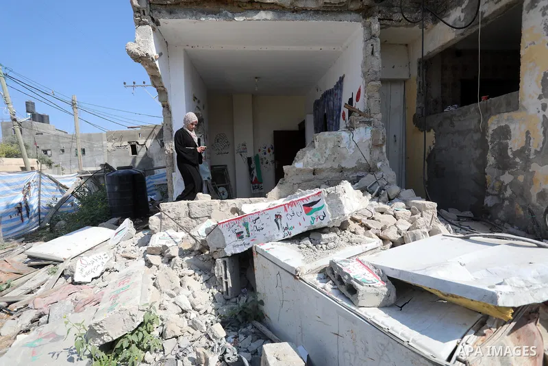 Palestinian artist Saja Moussa draws on broken tiles from her family's house in Rafah refugee camp, southern Gaza Strip, on June 26, 2021. The house was damaged last month during an 11-day war between Israel and the Hama...