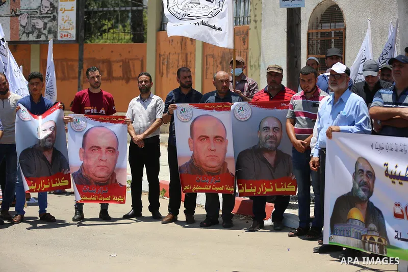Palestinian supporters of Al-Ahrar movement take part in a protest following the death of Nizar Banat, a Palestinian parliamentary candidate who criticised the Palestinian Authority and died after being arrested by PA se...