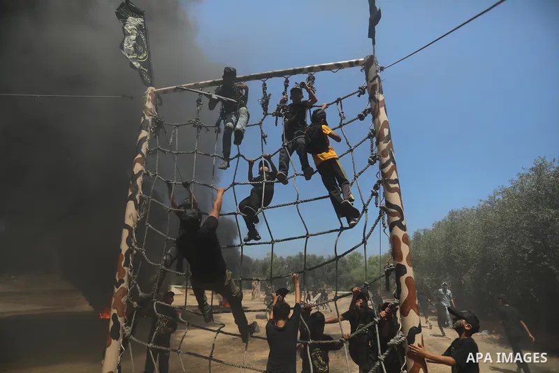Young Palestinians attend a military summer camp organised by the Islamic Jihad Movement, in Gaza City, June 26, 2021. Photo by Ashraf Amra