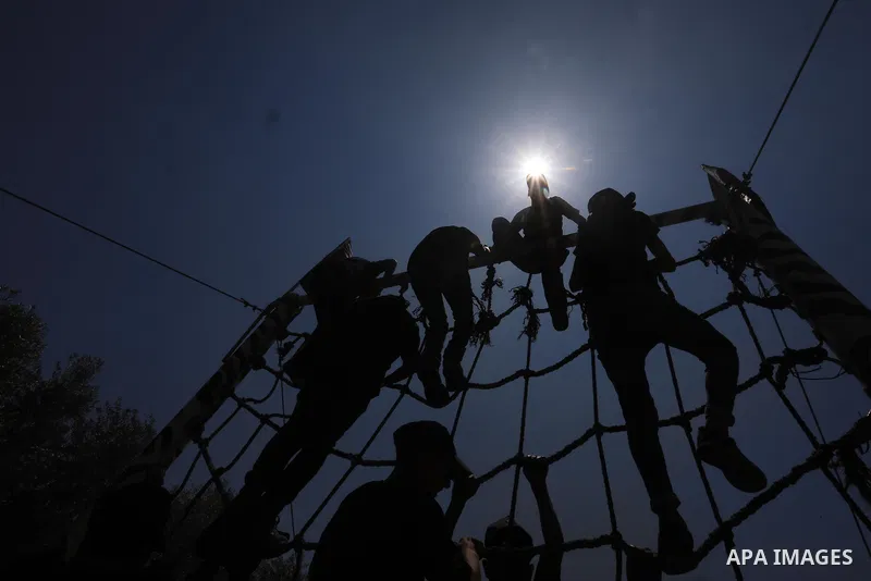 Young Palestinians attend a military summer camp organised by the Islamic Jihad Movement, in Gaza City, June 26, 2021. Photo by Ashraf Amra