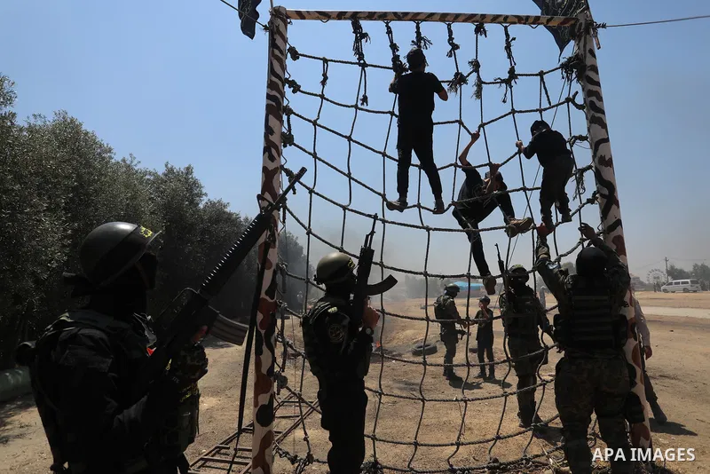 Young Palestinians attend a military summer camp organised by the Islamic Jihad Movement, in Gaza City, June 26, 2021. Photo by Ashraf Amra