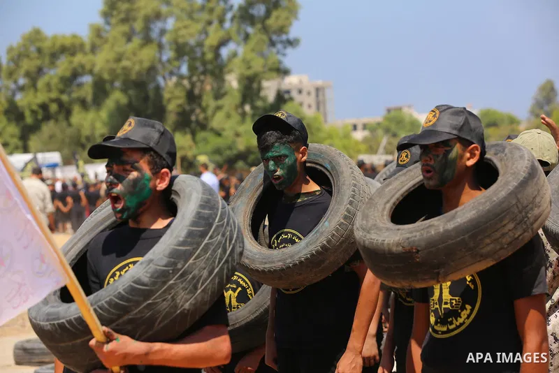 Young Palestinians attend a military summer camp organised by the Islamic Jihad Movement, in Gaza City, June 26, 2021. Photo by Ashraf Amra