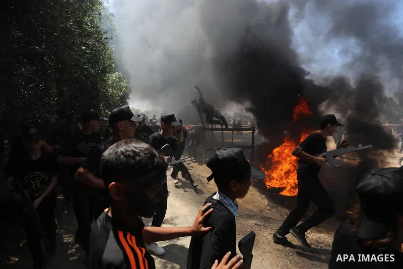 Young Palestinians attend a military summer camp organised by the Islamic Jihad Movement, in Gaza City, June 26, 2021. Photo by Ashraf Amra